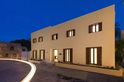 a white building with a street in front of it at Old Town Senses Boutique Hotel in Rhodes Town