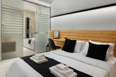 a bedroom with a large bed with towels on it at Old Town Senses Boutique Hotel in Rhodes Town