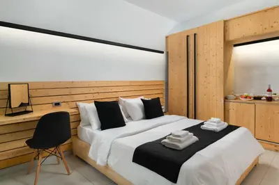 a bedroom with a large bed with a desk and a chair at Old Town Senses Boutique Hotel in Rhodes Town