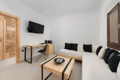 a living room with a white couch and a table at Old Town Senses Boutique Hotel in Rhodes Town
