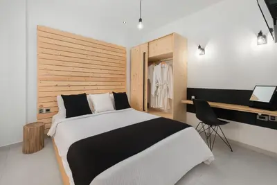 a bedroom with a black and white bed and a desk at Old Town Senses Boutique Hotel in Rhodes Town