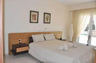 a bedroom with a bed with two towels on it at Beautiful house with garden in Rhodes in Ialyssos