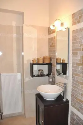 a bathroom with a sink and a mirror at Beautiful house with garden in Rhodes in Ialyssos