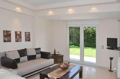 a living room with a couch and a coffee table at Beautiful house with garden in Rhodes in Ialyssos