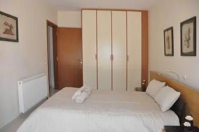 a bedroom with a bed with two towels on it at Beautiful house with garden in Rhodes in Ialyssos