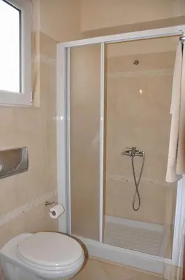 a bathroom with a shower with a toilet and a sink at Beautiful house with garden in Rhodes in Ialyssos
