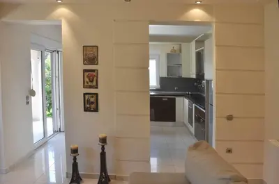 a kitchen with a couch and a counter in a room at Beautiful house with garden in Rhodes in Ialyssos