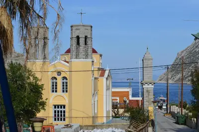 a yellow church with a cross on top of it at 