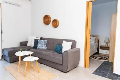 a living room with a couch and a table at Dimitras Luxus House in Archangelos