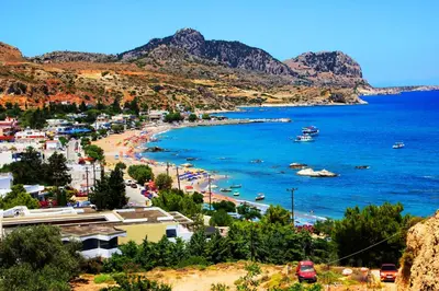 a view of a beach with boats in the water at Dimitras Luxus House in Archangelos