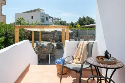 a balcony with a table and chairs on a patio at Villa Bella with Private Pool and Hot Tub in Lardos