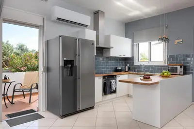 a kitchen with a stainless steel refrigerator at Villa Bella with Private Pool and Hot Tub in Lardos