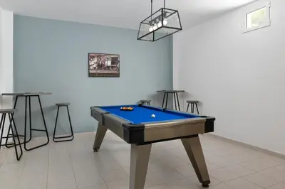 a pool table in a room with stools at Villa Bella with Private Pool and Hot Tub in Lardos