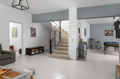a living room with a staircase and a couch at Villa Bella with Private Pool and Hot Tub in Lardos