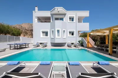 a villa with a swimming pool in front of a house at Villa Bella with Private Pool and Hot Tub in Lardos