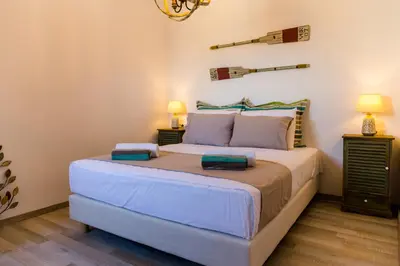 a bedroom with a large bed with two night stands at Lindos SeaView Apartment in Líndos