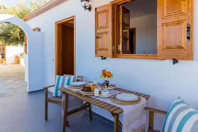 a table and chairs with food on it on a patio at Lindos SeaView Apartment in Líndos