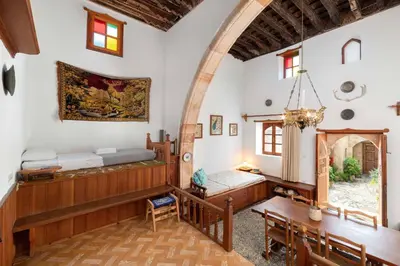 a room with a bed and a table and chairs at Captains House in Líndos