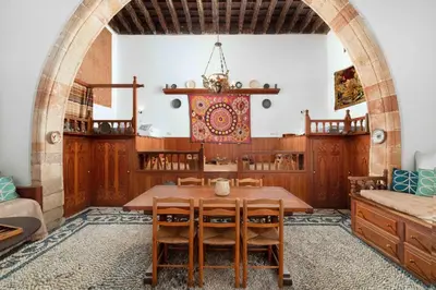 a dining room with a wooden table and chairs at Captains House in Líndos