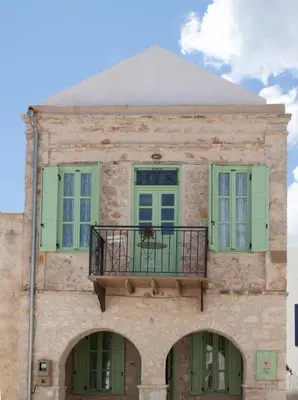 a building with a balcony on top of it at Villa Klytia in Halki