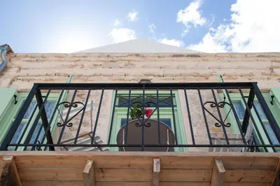 a balcony with a window with a plant on it at Villa Klytia in Halki