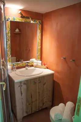 a bathroom with a sink and a mirror and a toilet at Villa Klytia in Halki