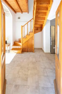 a hallway with wooden stairs and a refrigerator at Maison Roxanne & Maisonette in medieval city by Rhodes4vacation in Rhodes Town