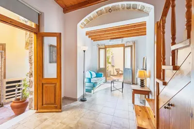 a living room with a wooden door and a blue couch at Maison Roxanne & Maisonette in medieval city by Rhodes4vacation in Rhodes Town