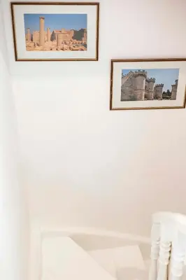 two framed photographs hanging on a white wall at Maison Roxanne & Maisonette in medieval city by Rhodes4vacation in Rhodes Town