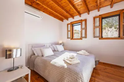 a bedroom with a bed with towels on it at Maison Roxanne & Maisonette in medieval city by Rhodes4vacation in Rhodes Town