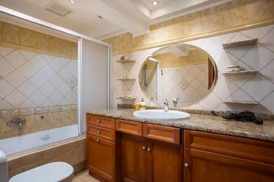 a bathroom with a sink and a toilet and a mirror at Christine Villa Pefkos in Pefki Rhodes