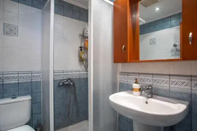 a bathroom with a sink and a toilet at Christine Villa Pefkos in Pefki Rhodes