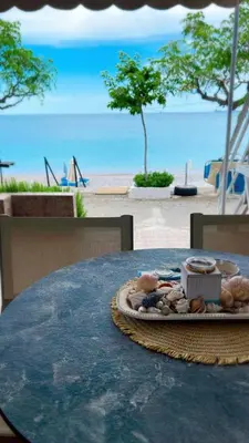 a table with a tray of food on top of the beach at Haraki Dream View in Haraki