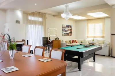 a living room with a ping pong table at Kallithea Breeze Luxury Villa in Koskinou