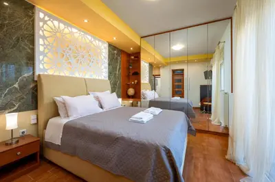 a bedroom with a bed and a large window at Kallithea Breeze Luxury Villa in Koskinou