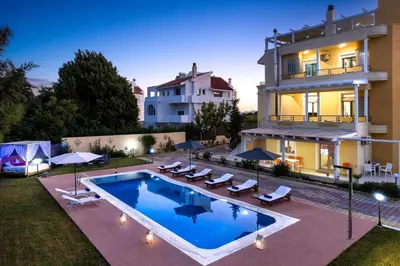 a house with a swimming pool in front of a building at Kallithea Breeze Luxury Villa in Koskinou