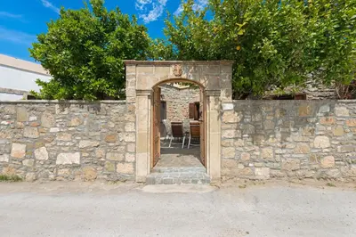 an entrance to a stone wall with an open door at Villa Claudia in Lardos in Lardos