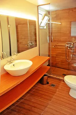 a bathroom with a sink and a shower and a toilet at Praxitelous 9 Old Town in Rhodes Town