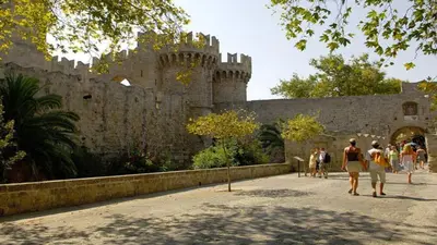 a group of people walking in front of a castle at Praxitelous 9 Old Town in Rhodes Town