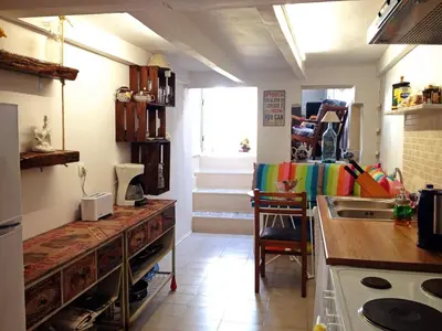 a kitchen with a counter and a sink and a table at Praxitelous 9 Old Town in Rhodes Town