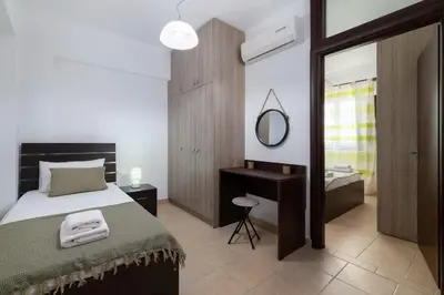a bedroom with a large bed and a mirror at Lindos Olive Suites in Líndos