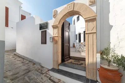 an archway leading to a patio in a house at Lindos Olive Suites in Líndos