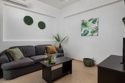 a living room with a couch and a table at Lindos Olive Suites in Líndos