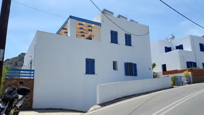 a white building with a motorcycle parked next to it at Zafeiris Apartments in Livadia