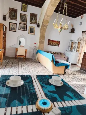 a living room with a couch and a table at Stam Luxury Traditional House in Koskinou