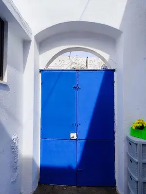 a blue door in a white wall with a doorway at Stam Luxury Traditional House in Koskinou