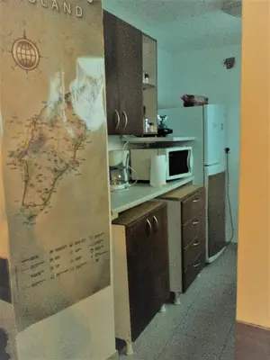 a kitchen with a map of the world on the wall at Stam Luxury Traditional House in Koskinou