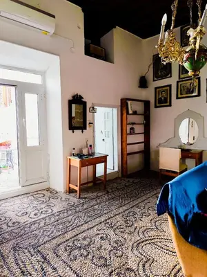 a living room with a couch and a table at Stam Luxury Traditional House in Koskinou