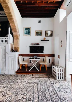 a living room with a table and two chairs at Stam Luxury Traditional House in Koskinou
