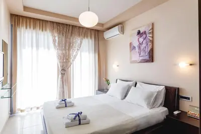 a bedroom with a large bed with two boxes on it at Bella Foresta Villa in Ialyssos